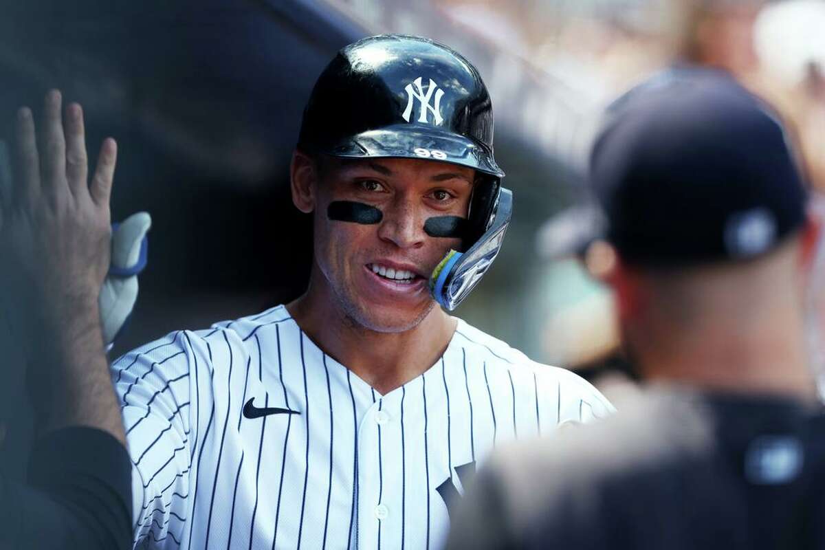 The New York Yankees' Aaron Judge is congratulated in the dugout after he hit a two-run home run against the Kansas City Royals during the third inning at Yankee Stadium on Saturday, July 30, 2022, in New York. (Rich Schultz/Getty Images/TNS)