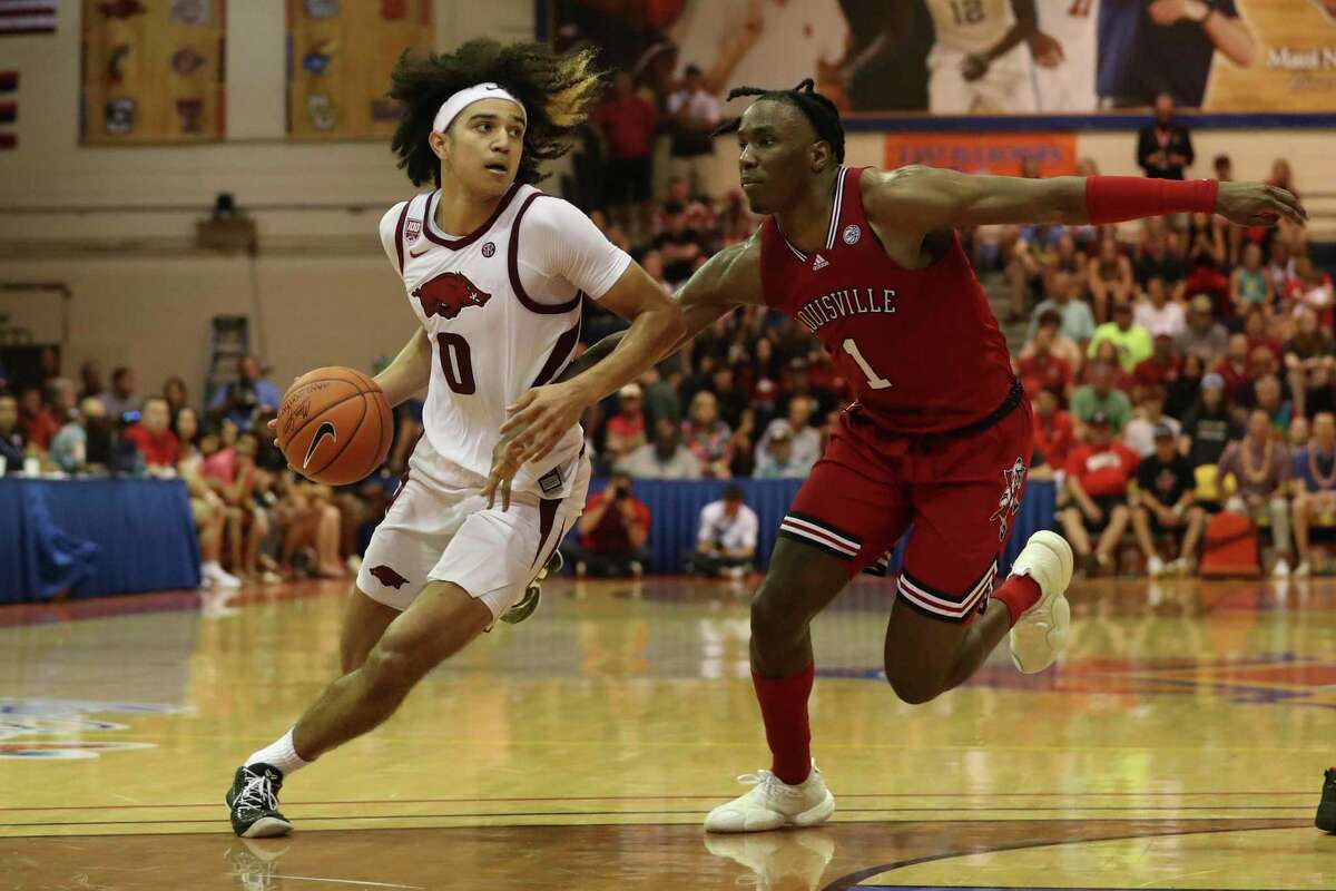 Arkansas guard Anthony Black, who scored 26 points, drives past Louisville’s Mike James in the Maui Invitational.