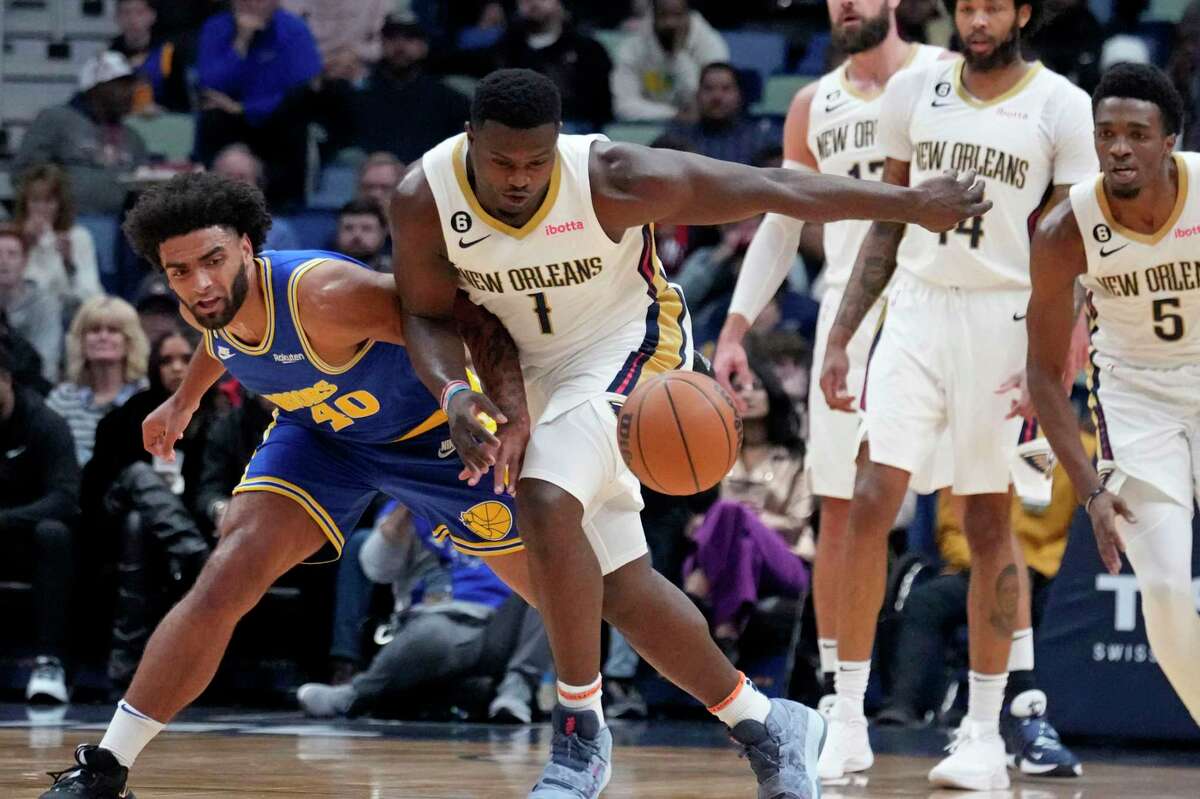 New Orleans Pelicans forward Zion Williamson (1) and Golden State Warriors forward Anthony Lamb (40) chase down a loose ball in the first half of an NBA basketball game in New Orleans, Monday, Nov. 21, 2022. (AP Photo/Gerald Herbert)