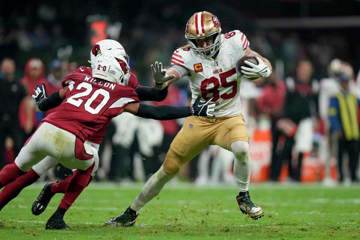 San Francisco 49ers tight end George Kittle, right, gets past Arizona Cardinals cornerback Marco Wilson (20) and safety Budda Baker, on his way to scoring a touchdown during the first half of an NFL football game Monday, Nov. 21, 2022, in Mexico City. (AP Photo/Fernando Llano)