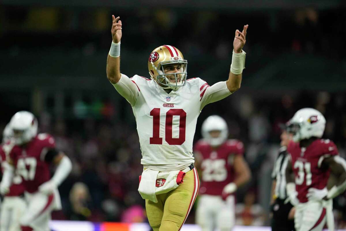 San Francisco 49ers quarterback Jimmy Garoppolo reacts after tight end George Kittle scored a touchdown during the second half of an NFL football game against the Arizona Cardinals, Monday, Nov. 21, 2022, in Mexico City. (AP Photo/Marcio Jose Sanchez)