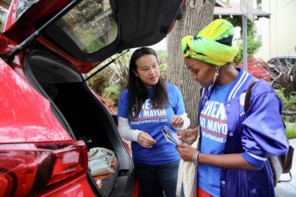 Oakland mayoral candidate and City Council Member Sheng Thao, left, converses with campaign volunteer Renia Webb as they canvass on Saturday, November 5, 2022, in Oakland, Calif.