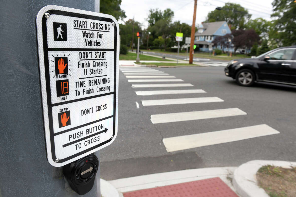 Pedestrian crossing road traffic sign showing a person on a zebra