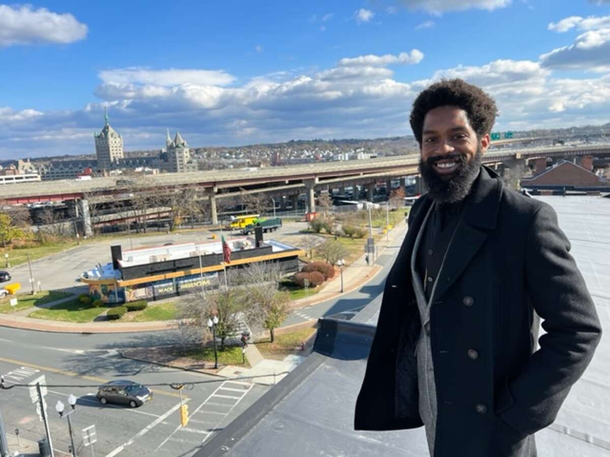 Travon Jackson on the rooftop of the African American Cultural Center of the Capital Region overlooking the South End Grocery at the intersection of Madison Avenue and South Pearl Street. and downtown Albany. 