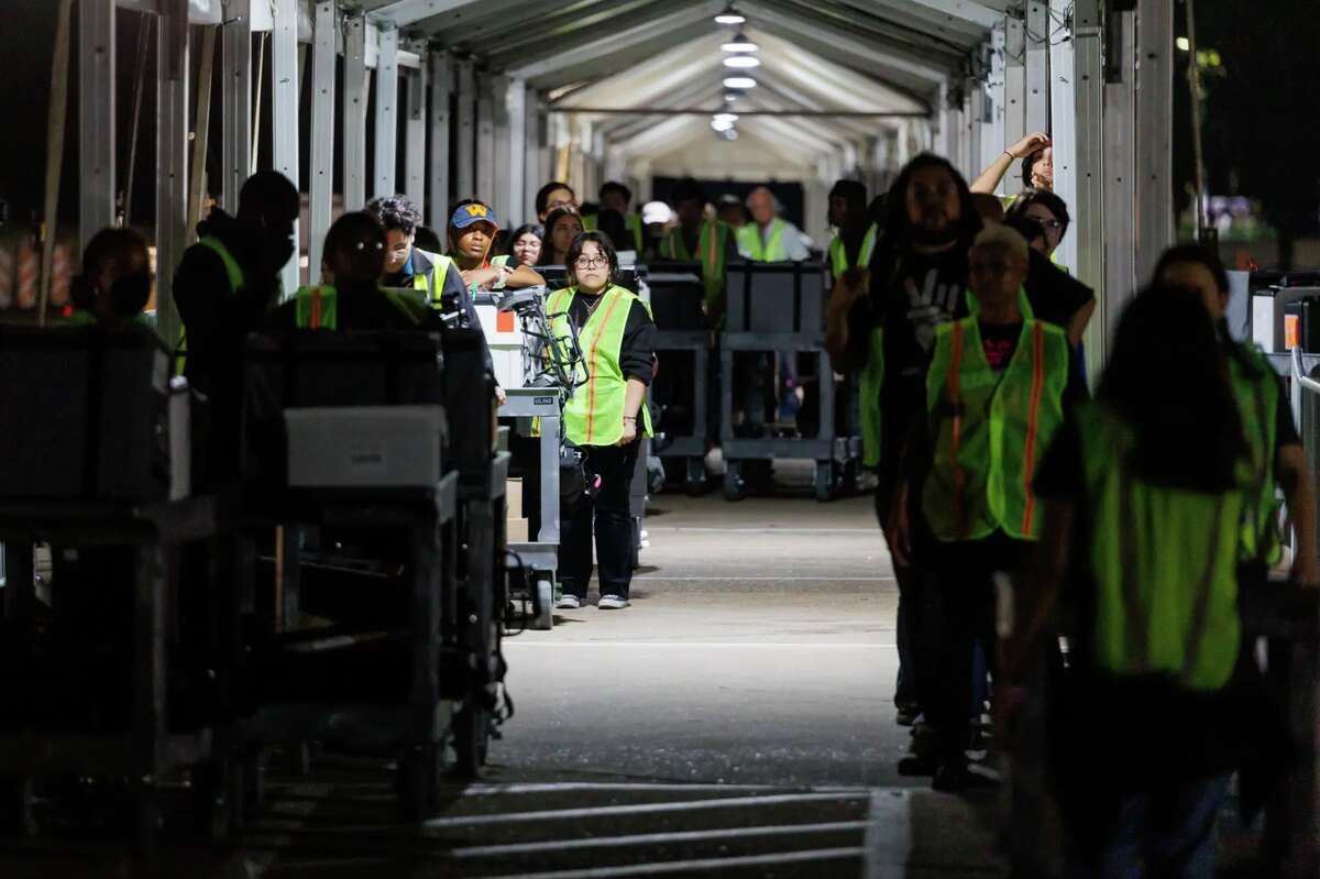 Ballots and scanning machines arrive at central counting after polls close in Houston on Nov. 8, 2022.