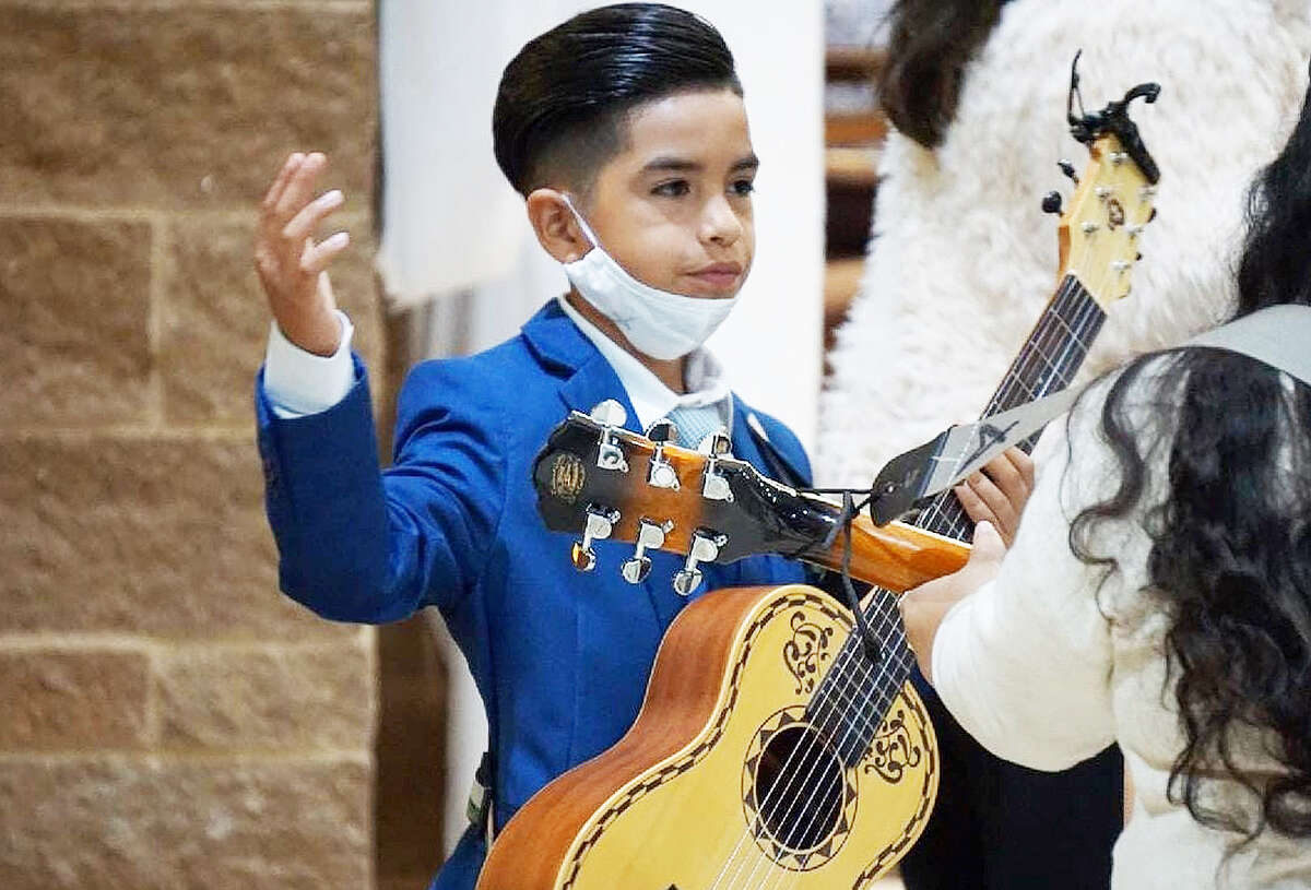 Eduardo Trevino finishes a song after playing his guitar and singing. The 10-year-old Humble ISD student just returned from San Antonio where he won first place in his category at the Mariachi Extravaganza national competition.