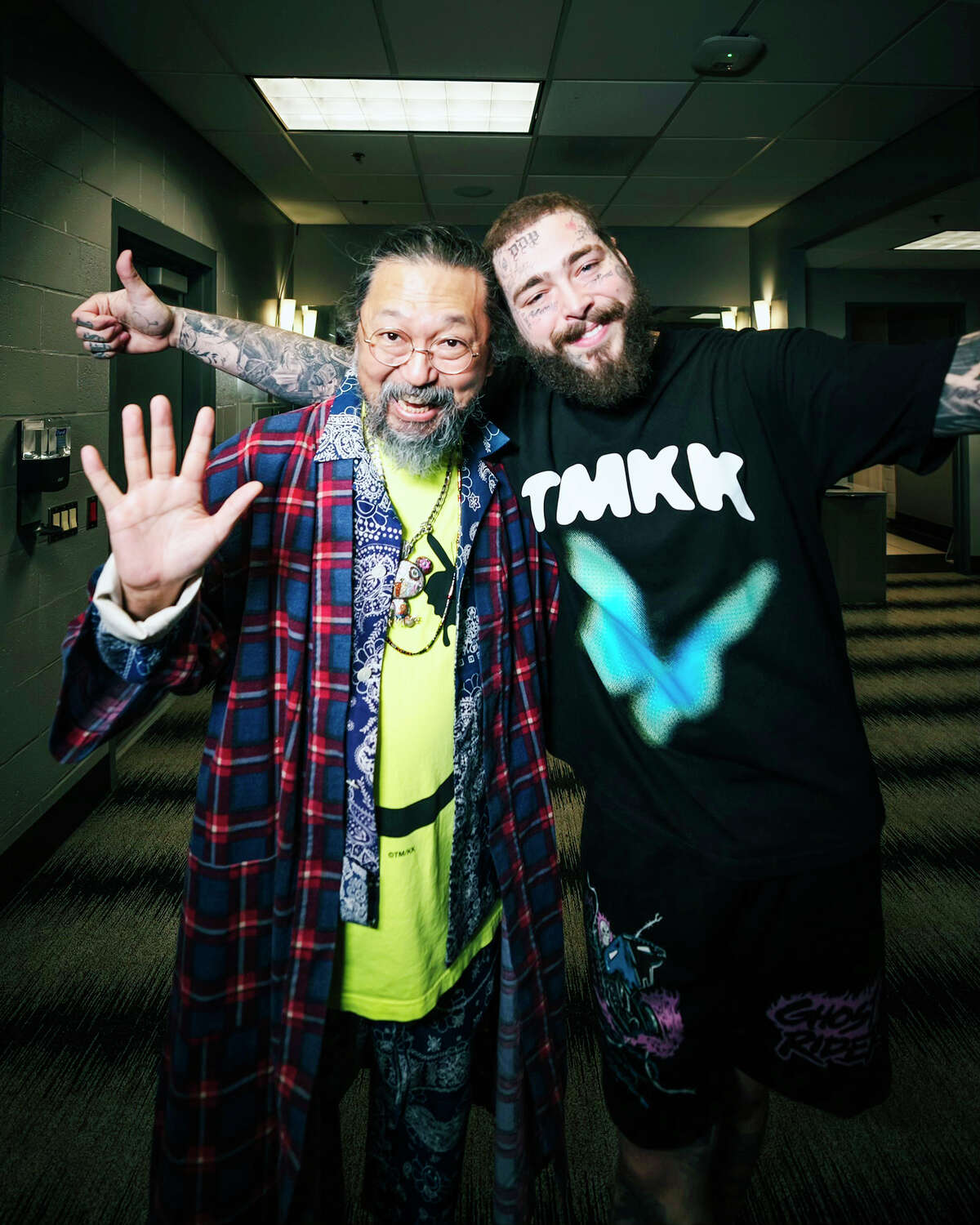 Japanese artist Takashi Murakami (left) and American rapper and singer Post Malone take a photo together Nov. 15 during Malone's concert at Crypto.com Arena in Los Angeles. Murakami created various artworks and products, featured in a pop-up store in Los Angeles, during Malone's tour for his latest album, "Twelve Carat Toothache."