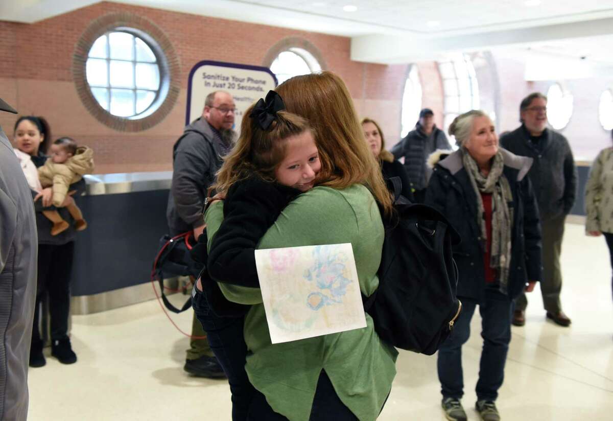 Shea Stalker gives a big hug to mom, Kristen, after her family is reunited at Albany International Airpot after taking separate flights from Orlando days earlier to visit with family over Thanksgiving on Tuesday, Nov. 22, 2022, in Colonie, N.Y.