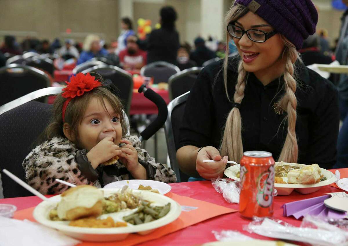 Judiah Morales and her daughter Chrescent Galvan Morales enjoy the 40th annual Jimenez Thanksgiving dinner in 2019. After a two year hiatus, the dinner — a reminder to never underestimate the heart of San Antonio — will be back in person.