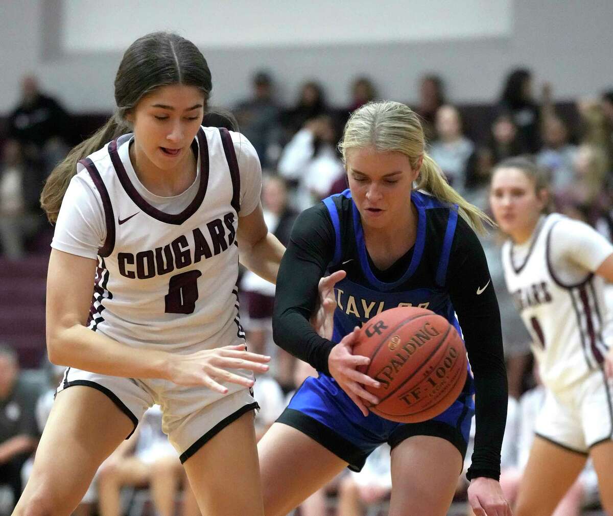 Cinco Ranch's Sofia Budnik (0) chases a loose ball with Katy Taylor's Olivia Upshaw (2) during the first half of a District 19-6A girls high school basketball game at Cinco Ranch High School on Tuesday, Nov. 22, 2022 in Katy.
