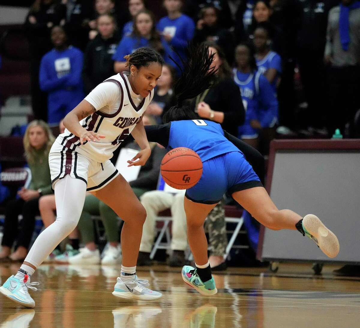 Cinco Ranch's Danielle Williams (15) steals the ball from Katy Taylor's Micah Elegores (0) during the second half of a District 19-6A girls high school basketball game at Cinco Ranch High School on Tuesday, Nov. 22, 2022 in Katy. Cinco Ranch won the game 53-48.
