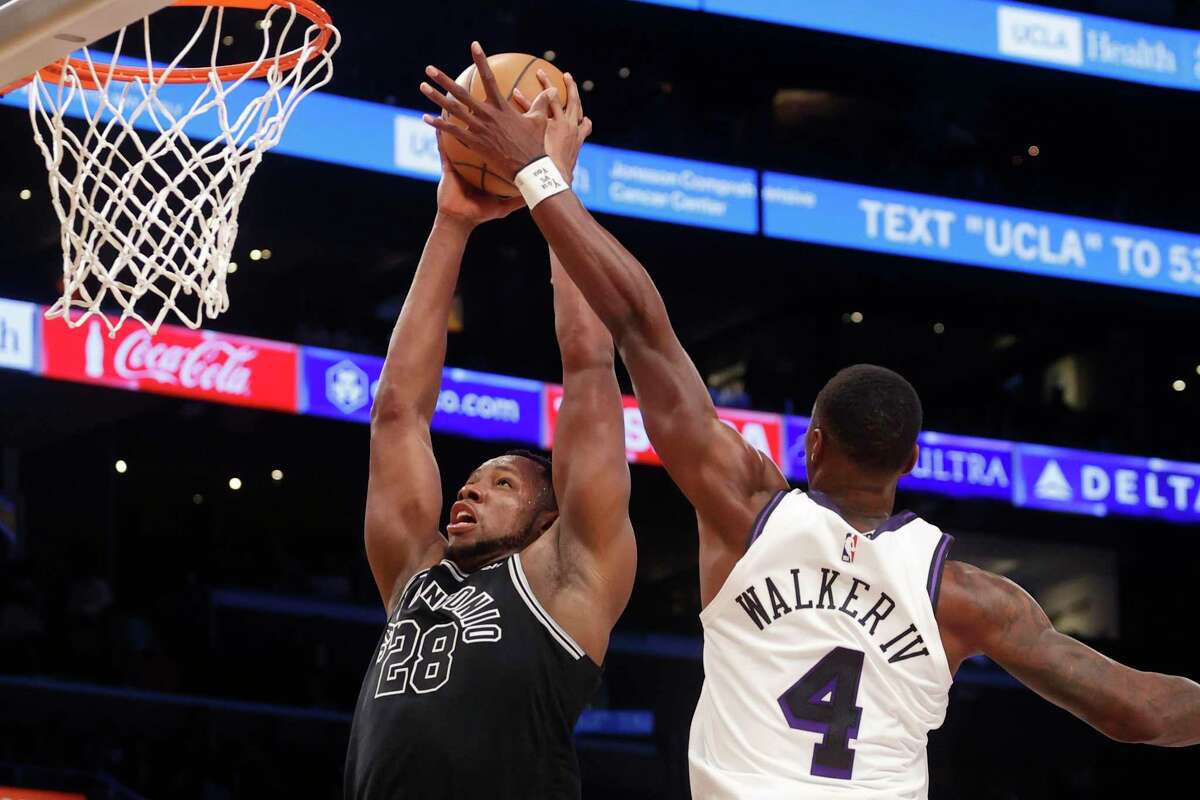 San Antonio Spurs center Charles Bassey (28) goes up to basket against Los Angeles Lakers guard Lonnie Walker IV (4) during the second half of an NBA basketball game Sunday, Nov. 20, 2022 in Los Angeles. (AP Photo/Ringo H.W. Chiu)