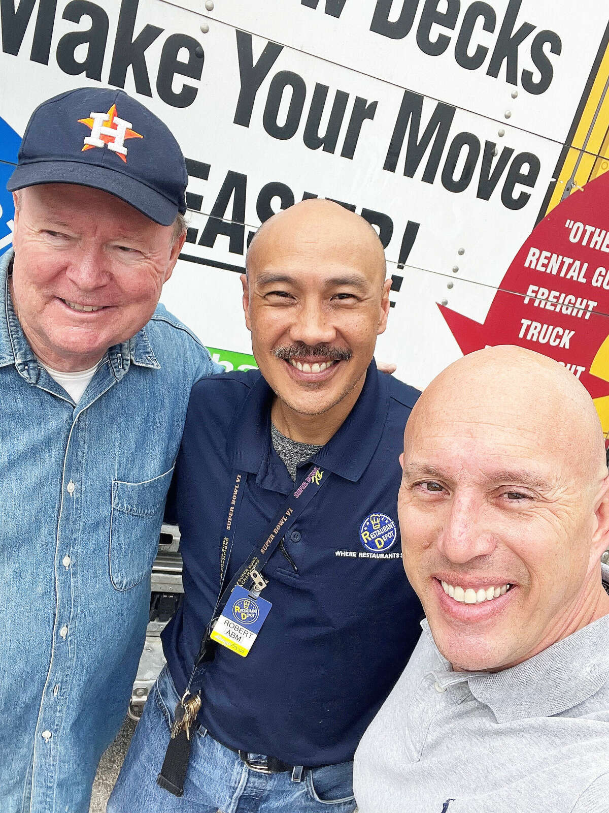 Larry Blair from the University Rotary Club and Tim Stroud from the Greater Houston Veterans Rotary Club get some help picking up turkeys and supplies from Robert at Restaurant Depot.