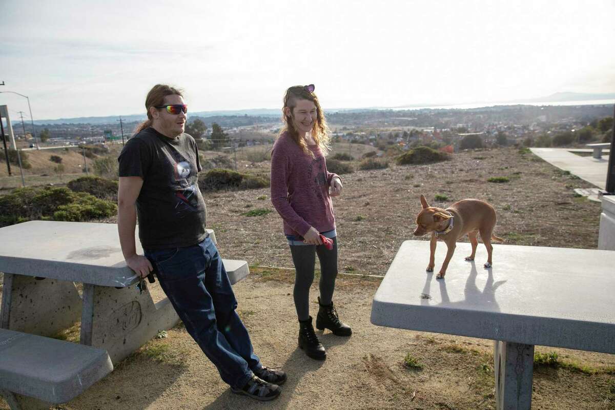 William Wells, left, and Megan Womack, center, with their dog Angel at the Hunter Hill rest area in Vallejo Calif., on Monday November 21, 2022. Hunter Hill rest area in Vallejo Calif., on Monday November 21, 2022.
