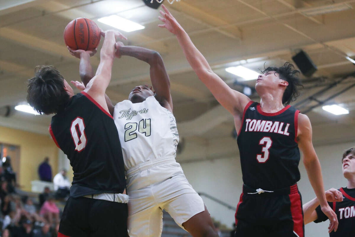 Conroe’s Rashaad Salih (24) shoots as he is fouled in the first quarter of a non-district high school basketball game at Conroe High School, Tuesday, Nov. 22, 2022, in Conroe.
