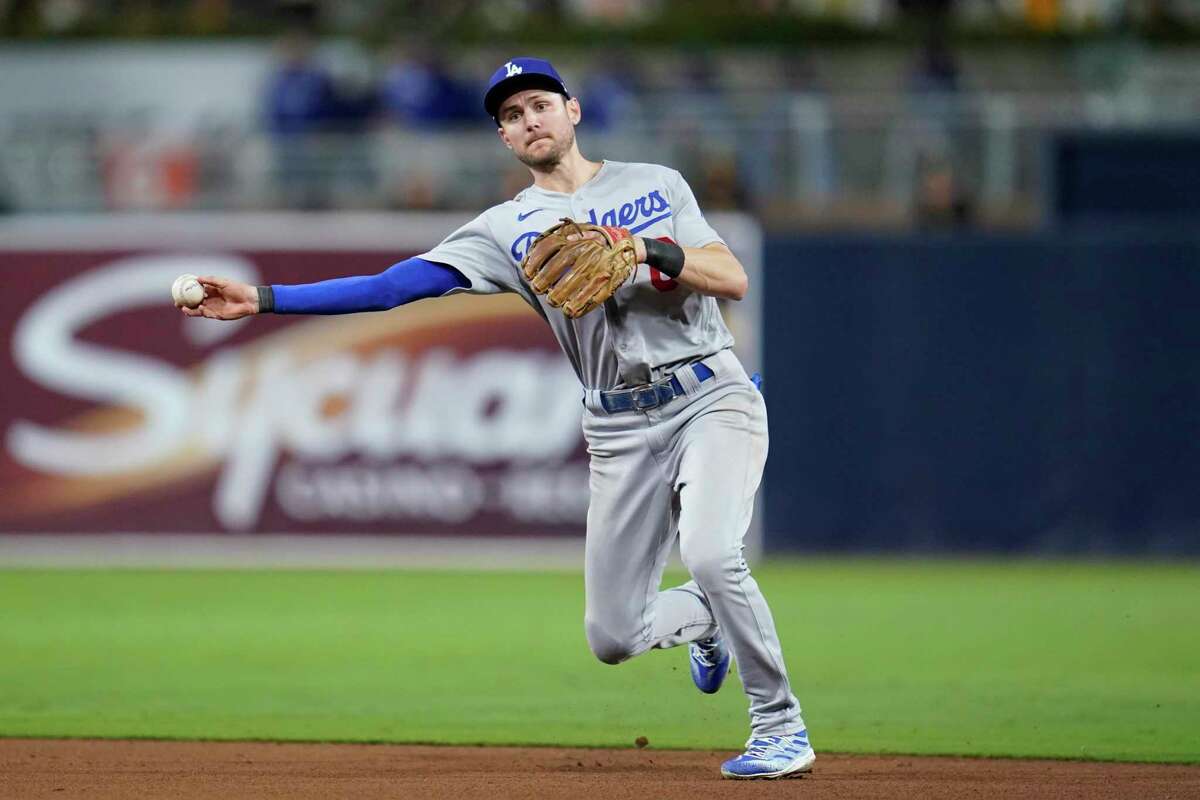 Los Angeles Dodgers shortstop Trea Turner throws to first for the out on San Diego Padres' Jake Cronenworth during the seventh inning in Game 3 of a baseball NL Division Series, Friday, Oct. 14, 2022, in San Diego. (AP Photo/Ashley Landis)