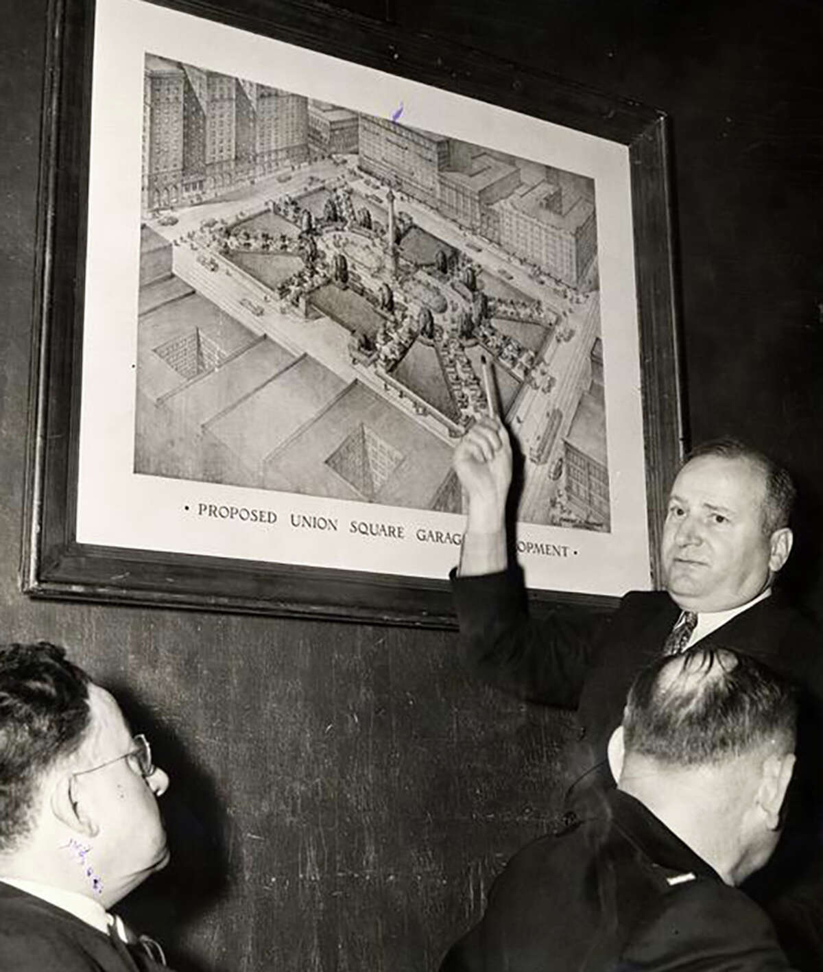 Timothy Pflueger, upper right, explaining plans for proposed Union Square parking garage, Dec. 12, 1940.
