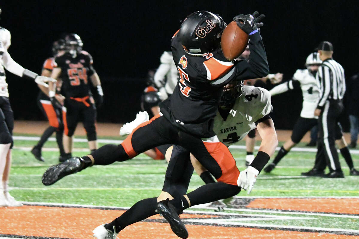 Shelton's Trevor Kiman dives to catch a pass during a football game between Shelton and Xavier at Finn Stadium, Shelton on Tuesday, Nov. 22, 2022.