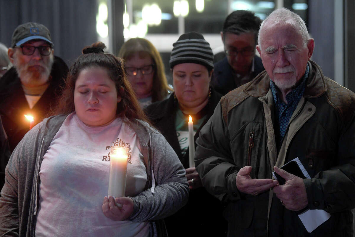 Robert Clark cries and prays while joining members of the community, including Anna Pacella, who gathered at the Event Centre for a candlelight vigil to mourn the victims of Saturday's fatal mass shooting at Club Q in Colorado Springs. Photo made Tuesday, November 22, 2022 Kim Brent/Beaumont Enterprise