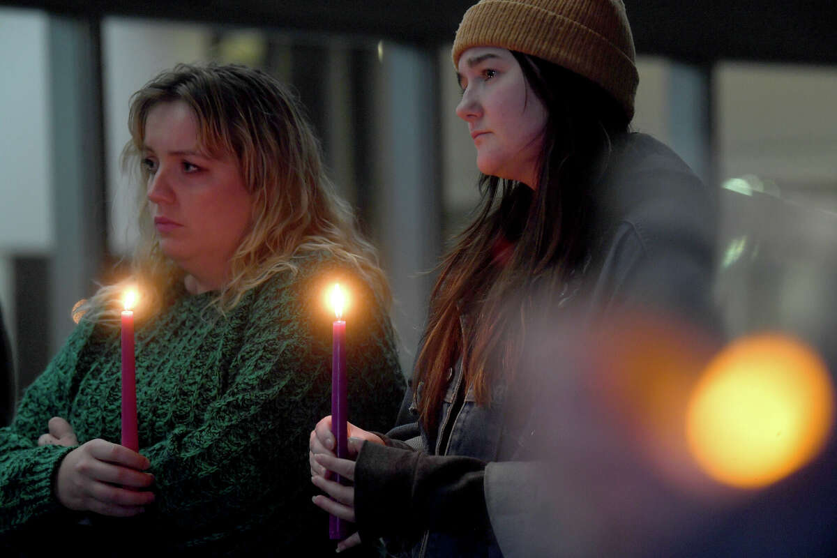 Members of the community, including Caitlin Grammer (left) and Emily Buesing, gathered at the Event Centre for a candlelight vigil to mourn the victims of Saturday's fatal mass shooting at Club Q in Colorado Springs. Photo made Tuesday, November 22, 2022 Kim Brent/Beaumont Enterprise