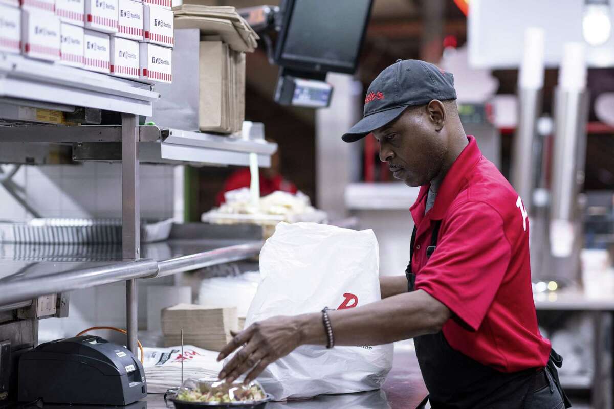 An employee prepares a takeout order at a restaurant in Chicago on Sept. 27, 2022.