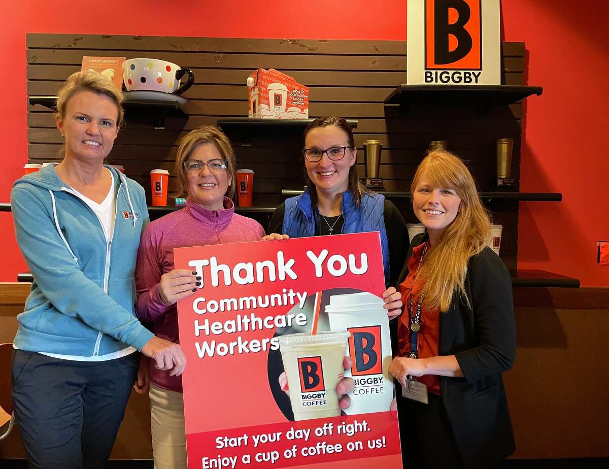 Biggby Coffee owners Tammy Lewandowski (far left) and Julie Denslow (second to far left) pose for a photo with Hospice of Michigan representatives Danielle Knight  (second to far right) and Cassandra Haner (far right) as the organization honored the coffee shop's support of healthcare workers.