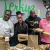 Delmar Morris; Isis-Rae Goulbourne; Joab Taylor; and Mario Lopez prepare for Jerkyz' Thanksgiving Day meal donations. 