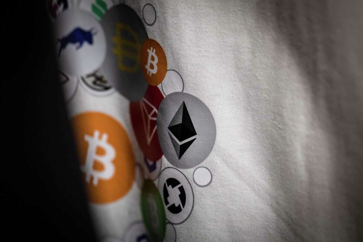 Bitcoin and ethereum logos on a t-shirt on display inside a cryptocurrency exchange in Barcelona, Spain, on Sept. 8, 2022.