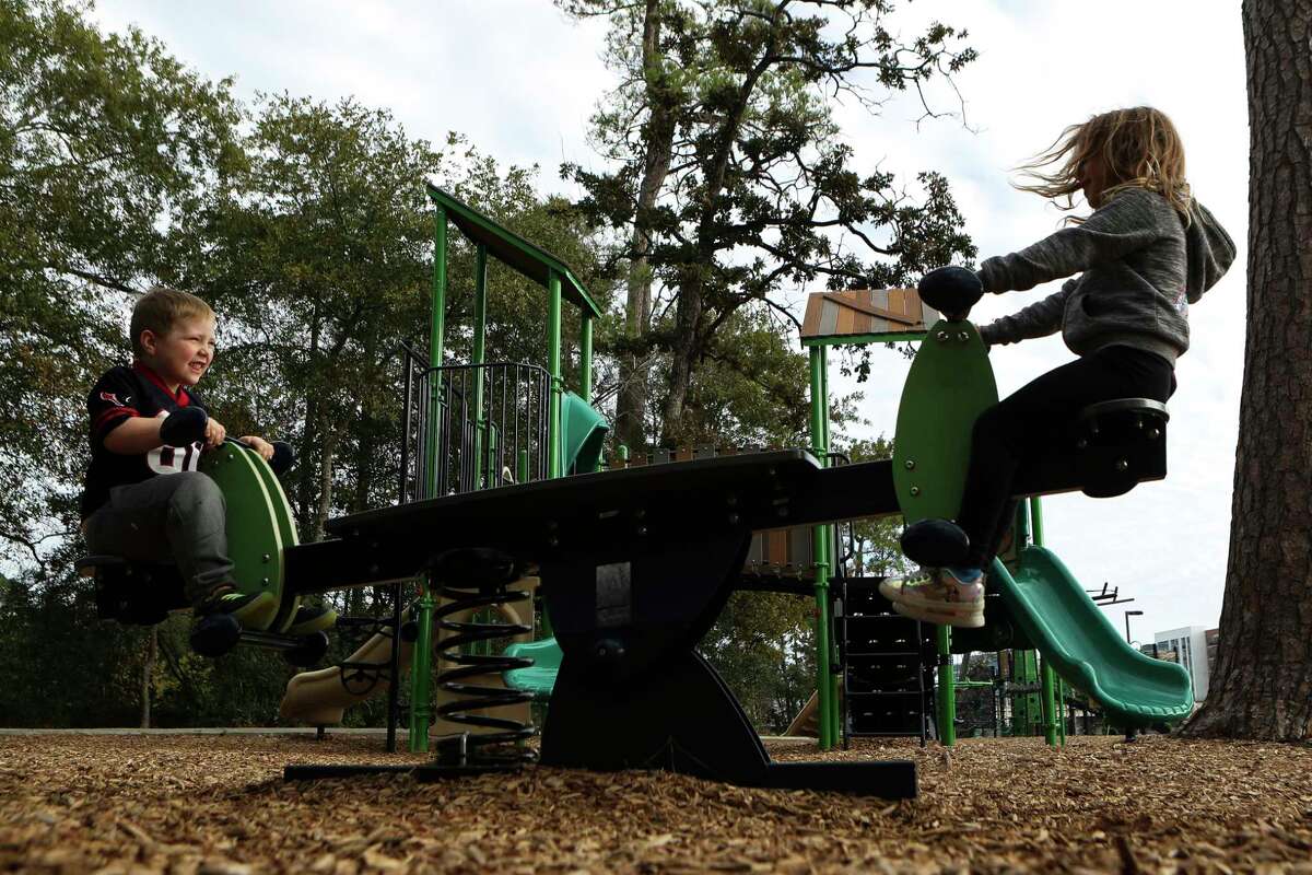 Children play on a seesaw and other playground equipment at Northshore Park, Tuesday, Nov. 22, 2022, in The Woodlands. With top-rated schools, plenty of green space, an active arts community, ease of transportation and its own children’s museum, The Woodlands has been named one of the best places to raise a family in a new report.