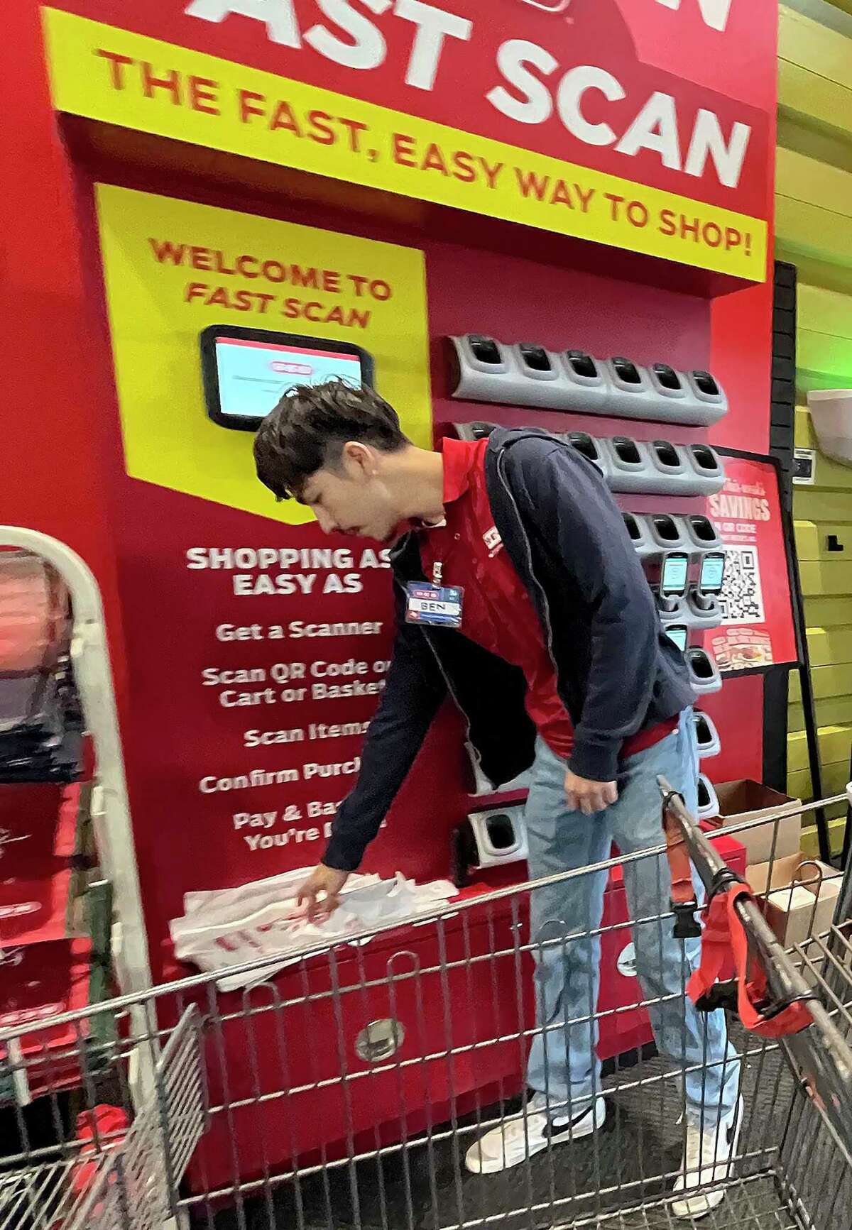 H-E-B is testing a checkout system called Fast Scan at its H-E-B Plus! in Schertz at Interstate 35 and Roy Richard Drive. To use the system, customers stop at the Fast Scan stand to pick up a handheld scanner as they enter the store. They return the scanner at checkout.