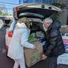 Greenwich Selectwoman Lauren Rabin and State Rep. Elect Hector Arzeno helped load up cars with Thanksgiving food to help more than 500 residents in need for the holiday.