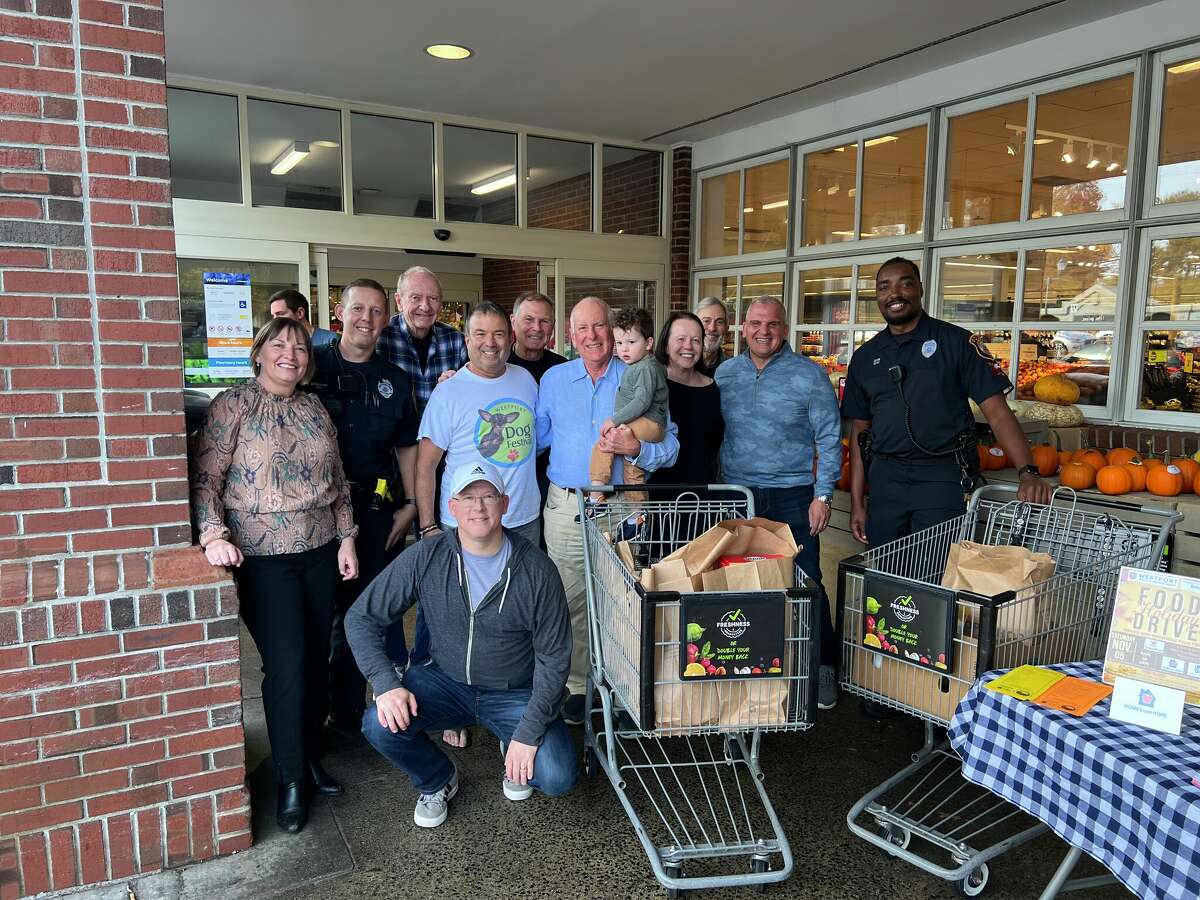 Members of the police department, Sunrise Rotary and other community members at the food drive at Stop and Shop in Westport. 