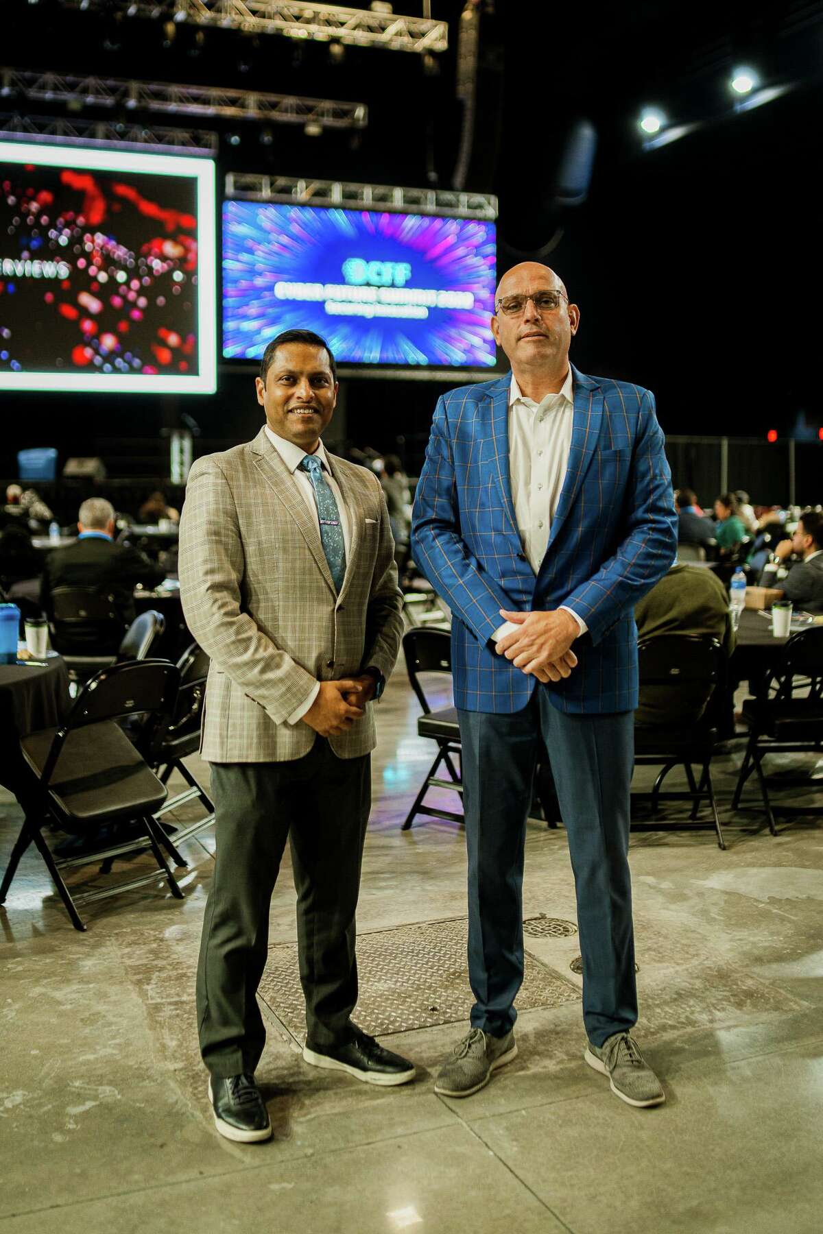 Valmiki Mukherjee - left, founder and chair of the Dallas-based Cyber Future Foundation, the organization that brought the Cyber Future Summit 2022 to Port San Antonio for the first time in October - stands with DeLorean Motor Co. CEO Joost de Vries during the conference.