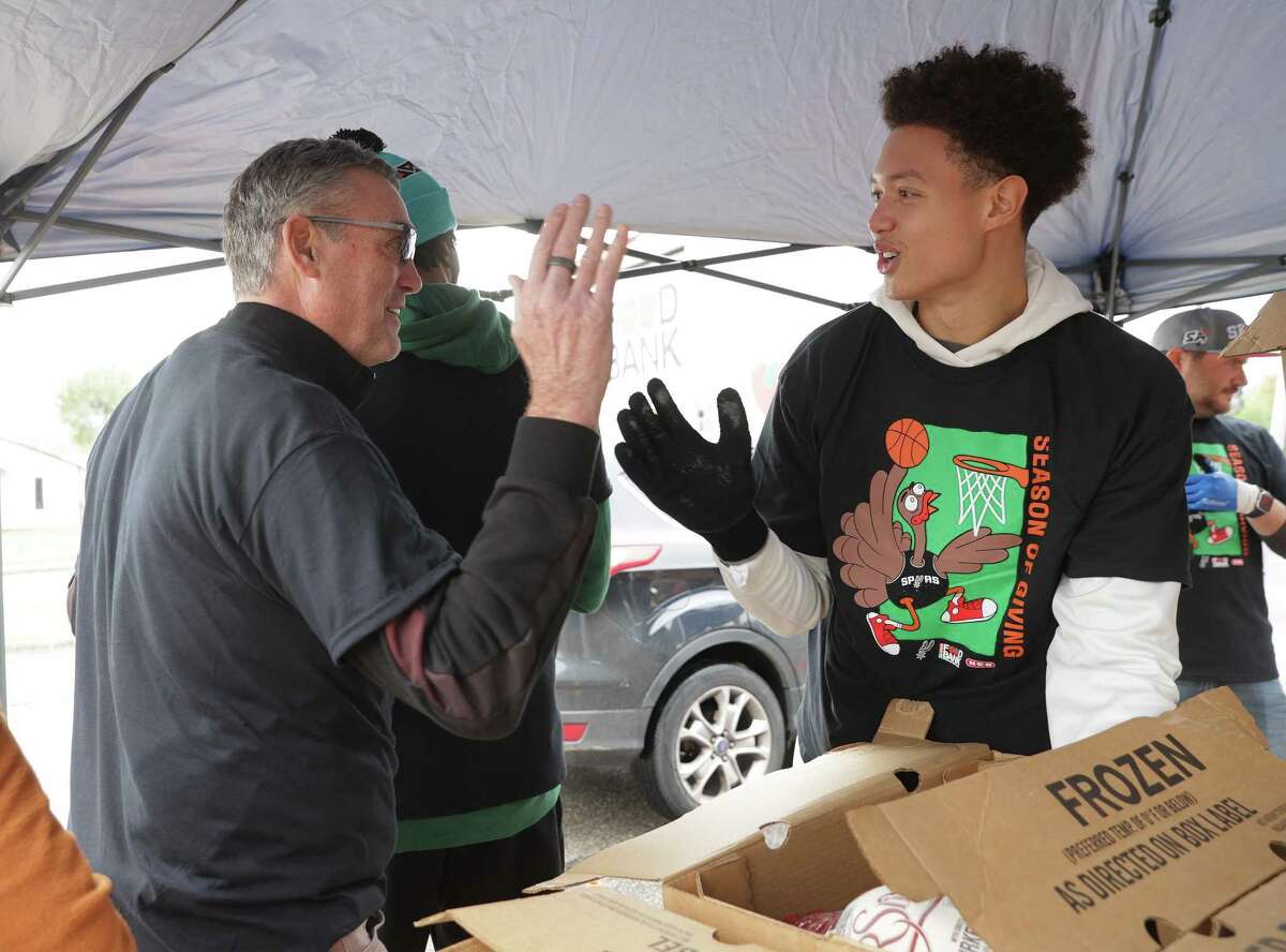 Spurs CEO R.C. Buford (left) greets player, Isaiah Roby, as the San Antonio Spurs, H-E-B and the San Antonio Food Bank help families celebrate Thanksgiving by donating 200 dinners to select Eastside families on Tuesday, Nov. 22, 2022. Spurs players joined SS&E employee volunteers to distribute turkeys along with all the sides and ticket vouchers for a future Spurs home game. This event kicks off the Spurs Season of Giving as one of many player engagements planned through December, making the holidays brighter in San Antonio. The Season of Giving is a five-week celebration during the holiday season when NBA teams give back by supporting and uplifting youth, families and organizations in their communities.