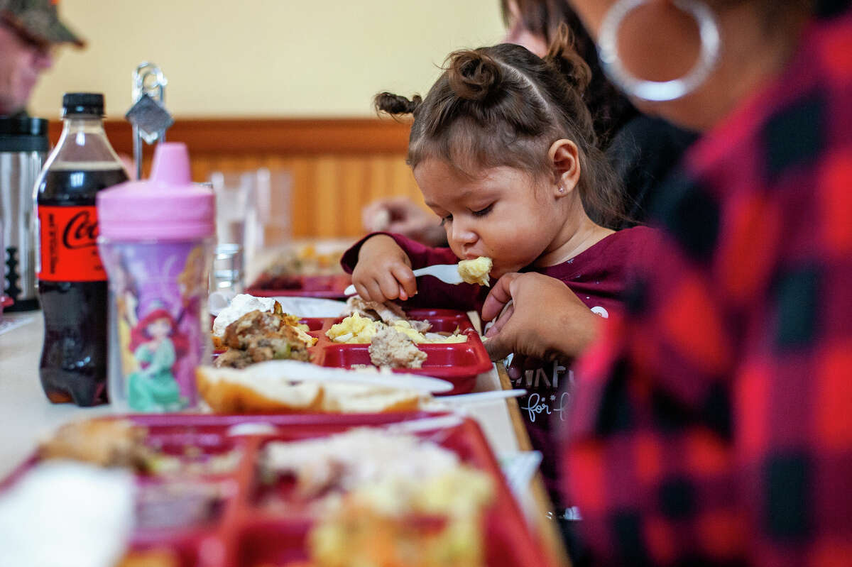 Midland resident ZZ Garza, 1, eats a Thanksgiving lunch on Nov. 23, 2022 at Midland's Open Door.