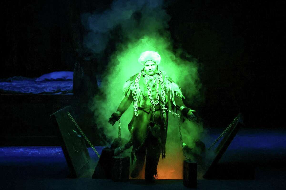 The troubled soul of Jacob Marley (Josh Rapp) descends into the depths after warning Scrooge (played by Jonathan Horne, not pictured) that he would be visited by three ghosts in the night, photographed during dress rehearsal for Midland Community Theater?•s production ?’A Christmas Carol?“ November 22, 2022. Photo Credit: The Oilfield Photographer, Inc.