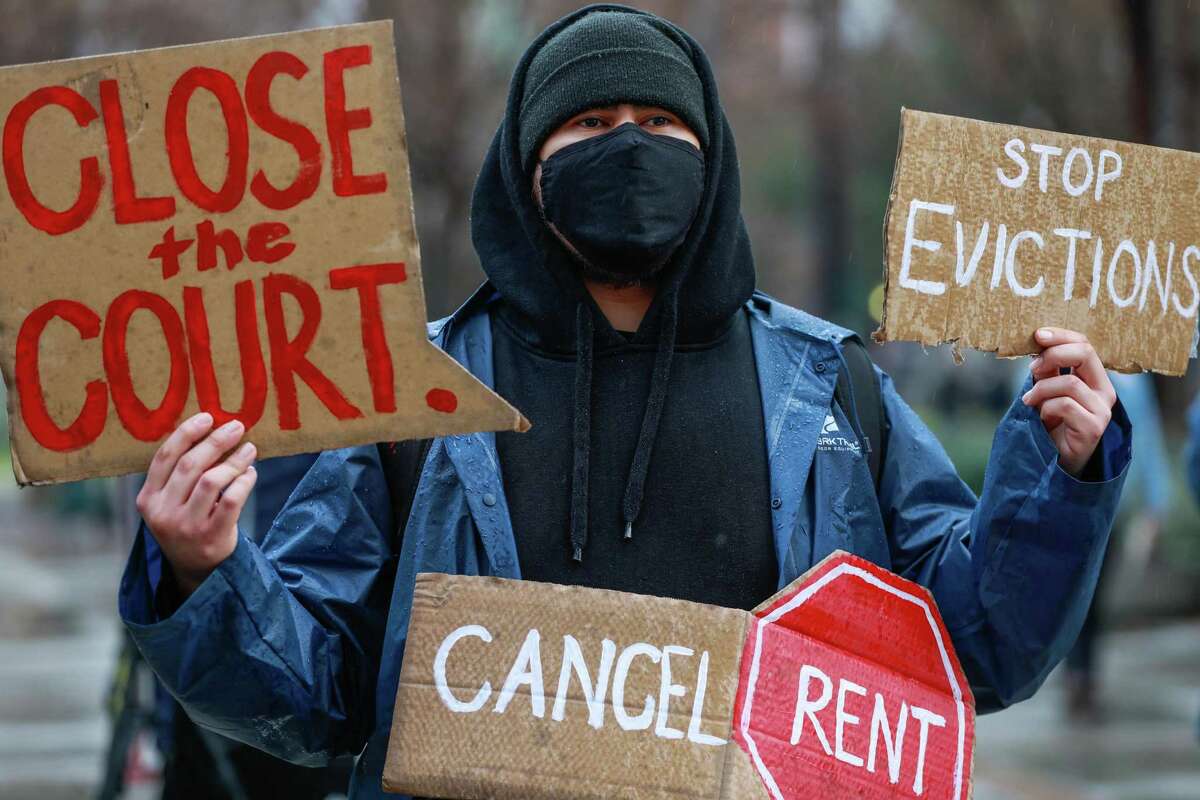 A demonstrator protests eviction proceedings outside the Santa Clara County Courthouse in San Jose in January 2021.