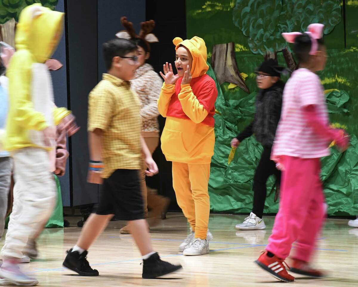 Fifth-grader Otavio Passos plays the role of Winnie the Pooh during the musical performance of "Winnie the Pooh KIDS" at New Lebanon School in the Byram section of Greenwich, Conn. Tuesday, Nov. 22, 2022. New Lebanon fifth-graders performed an adaptation of the A.A. Milne classic featuring songs from the original 2011 animated feature film plus new numbers by the renowned songwriting duo Robert and Kristen Lopez, of "Frozen" fame. The musical was directed and choreographed by Carol Pugliano featuring musical direction by Audrey Maurer.