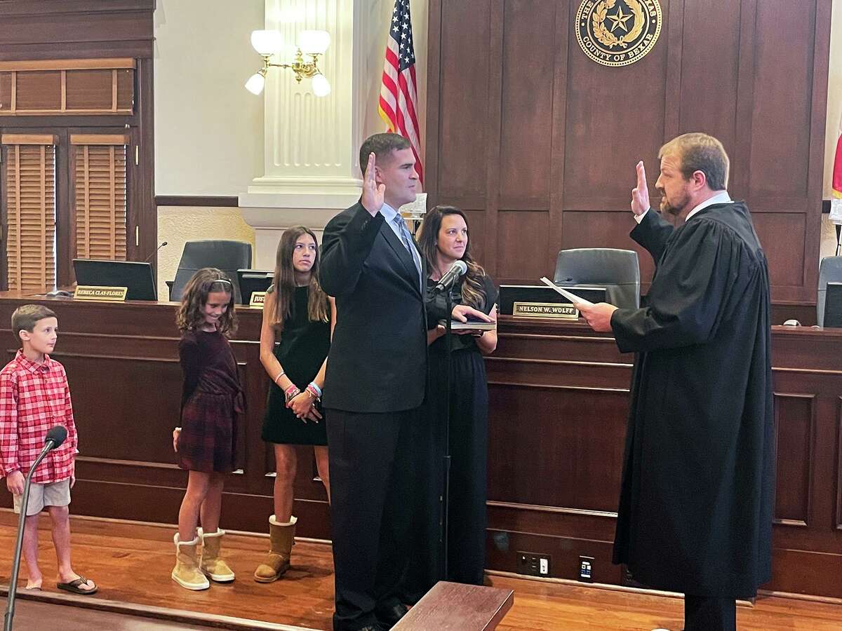 Grant Moody is sworn in as Bexar County commissioner for Precinct 3 with family at his side by County Court at Law Judge #11 Tommy Stolhandske on Wednesday.