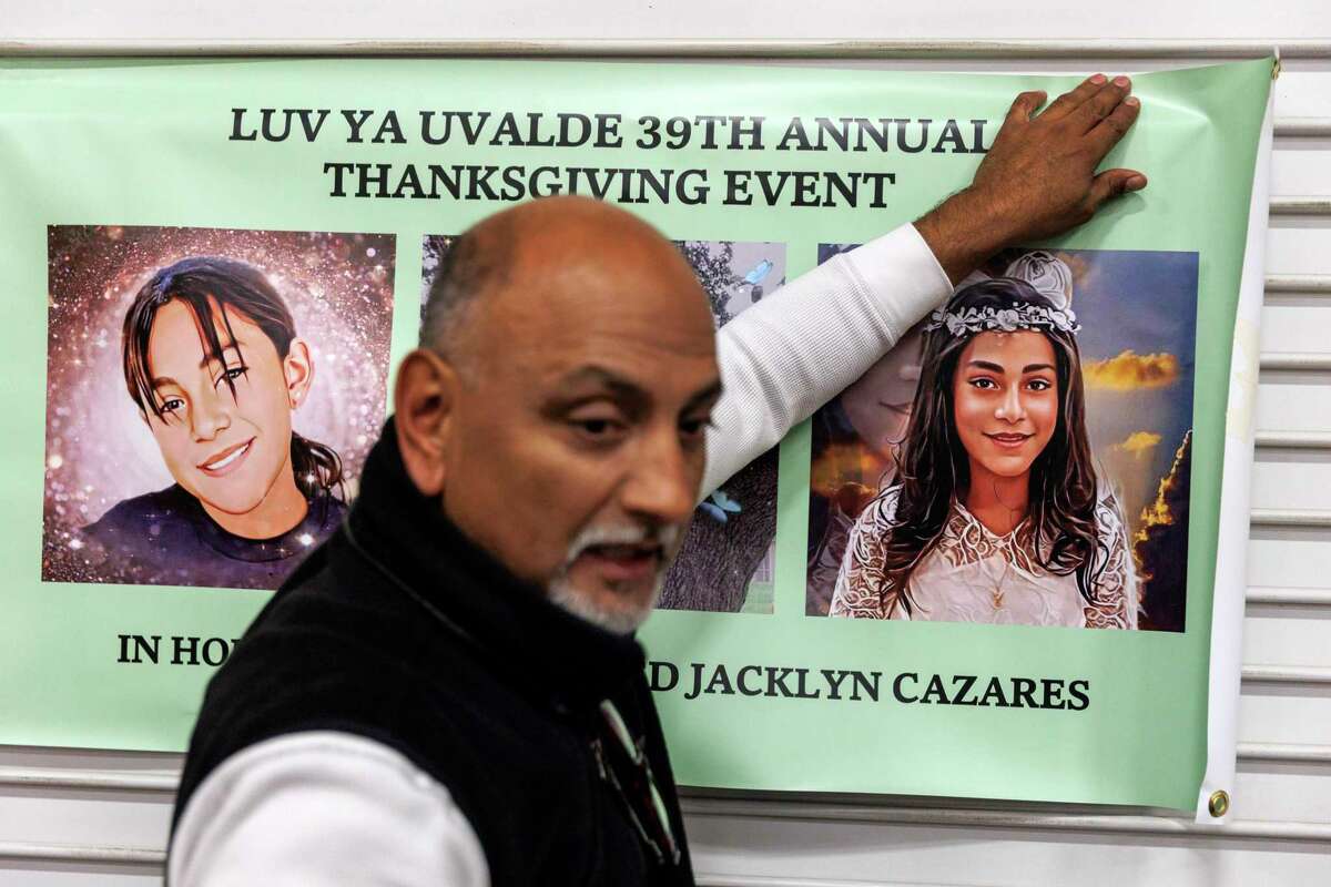 Jesse Rizo helps hang up a Luv Ya Uvalde sign Tuesday evening honoring his niece, Jacklyn “Jackie” Cazares, one of 19 children killed in the mass shooting at Robb Elementary six months ago,