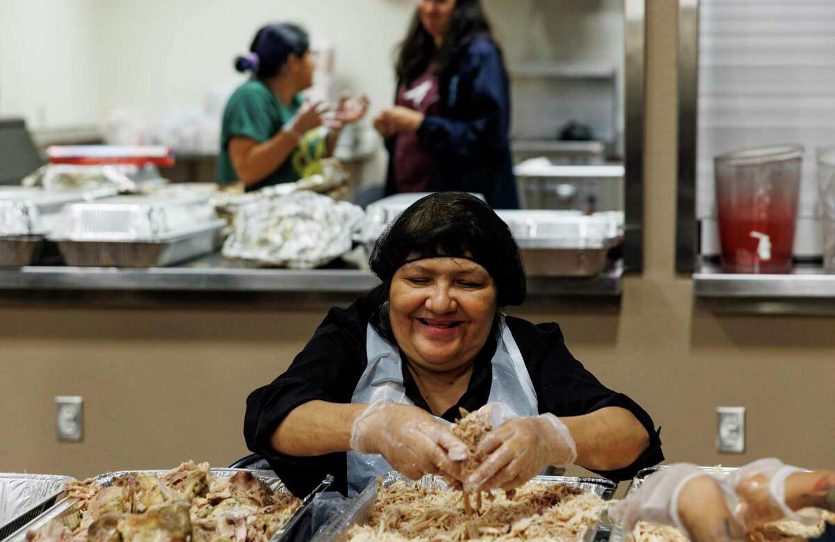 Polly Flores debones turkey as she prepares food for the 39th annual Luv Ya Uvalde Thanksgiving meal at the Uvalde County Fairplex Tuesday evening. Her niece, Jacklyn “Jackie” Cazares, and great niece Annabell Rodriguez were killed in the Robb Elementary shooting six months ago.