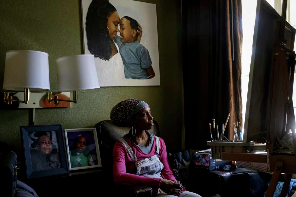 Michelle Brantley sits under a painting of herself with her son, Isaiah Lofton, at a Sacramento hotel. It’s been several years since Isaiah died as a teenager while at John Muir Medical Center’s pediatric intensive care unit after his spinal fusion surgical site became infected. Michelle is one of several parents who have had children die while being treated at John Muir. Brantley’s income was tied to being Isaiah’s full-time caregiver, so when he died she lost her income. Brantley now lives in a hotel room and works for Amazon while she looks for housing.