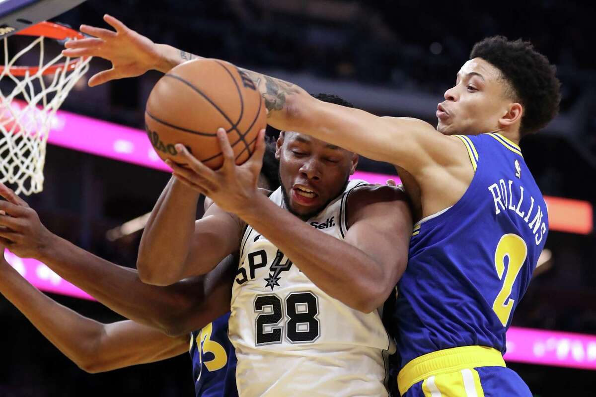 The Warriors’ Ryan Rollins defends against the Spurs’ Charles Bassey during a game earlier in November.