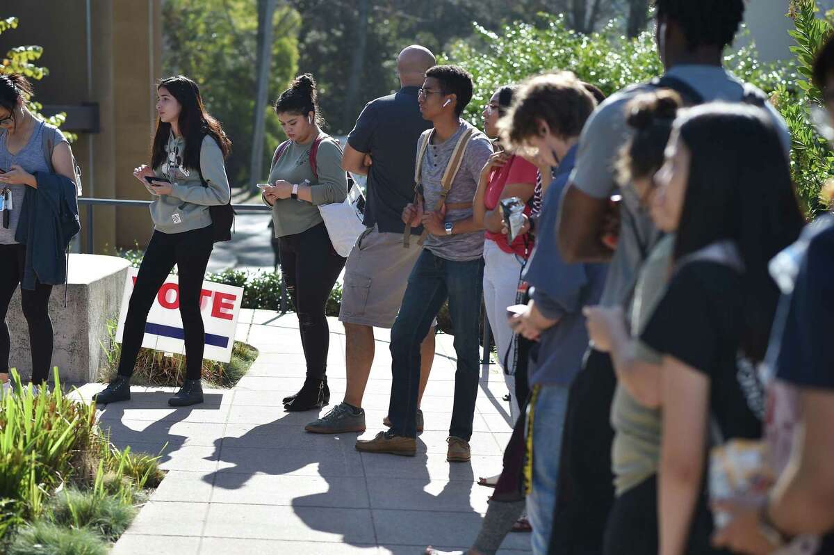 Students wait in line to vote on the UC Irvine campus, on Nove. 6, 2018. A federal appeals court on Wednesday rejected an appeal by a former psychiatry professor at UC Irvine who was fired after refusing to be vaccinated against COVID-19.