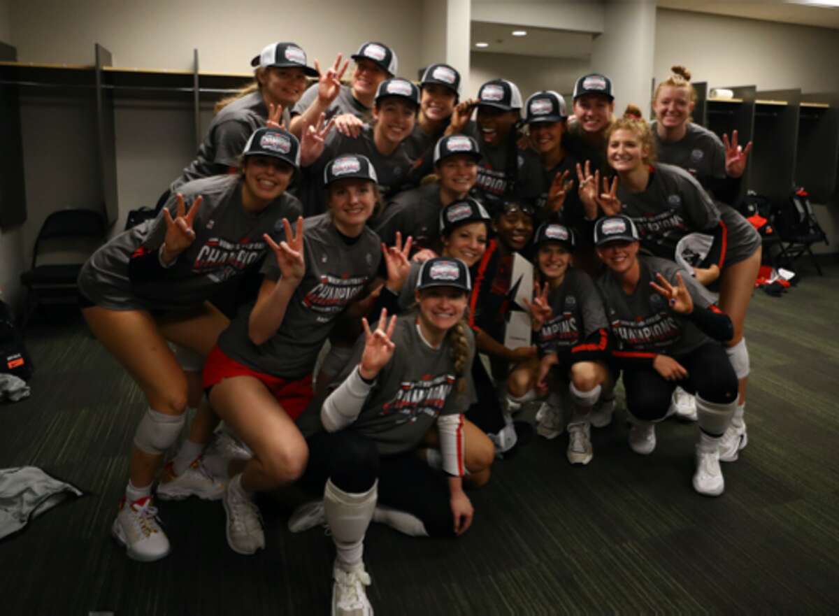 The UH volleyball team celebrates after winning the program's first conference title since 1999 after beating South Florida on Wednesday.
