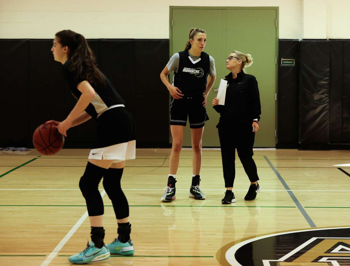 Sue Phillips, head girls basketball coach at Archbishop Mitty High School, converses with freshman McKenna Woliczko during team practice on Wednesday, November 16, 2022, in San Jose, Calif. Phillips, who is in her 30th season as head coach of the Monarchs, was recently inducted into the San Jose sports Hall of Fame and is a finalist for the women's basketball Hall of Fame.