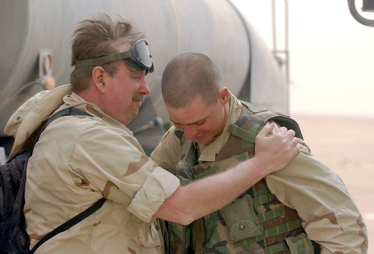 San Antonio Express News senior military reporter Sig Christenson embraces longtime family friend Jason Roberts, from Houston, on a chance meeting in March 2003 in the northern Kuwaiti desert.