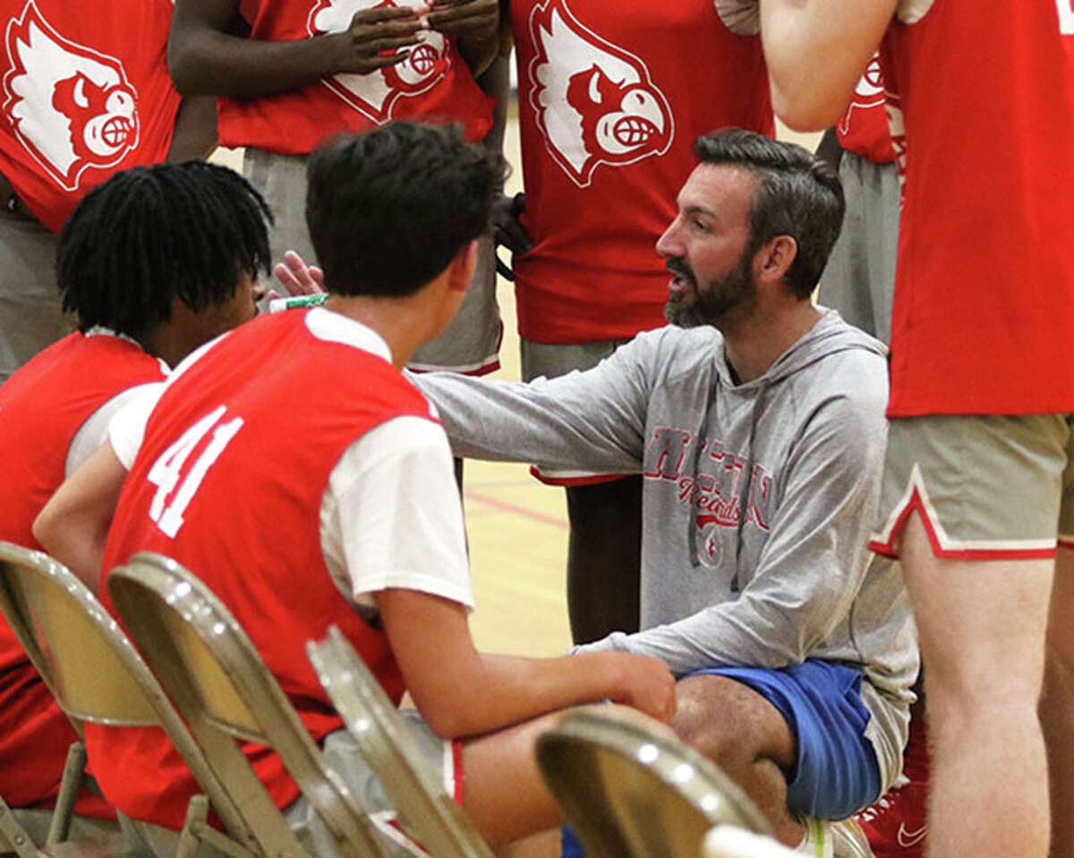 Alton coach Dylan Dudley instructs his Redbirds during a timeout in a summer tournament game in June at Edwardsville. On Wednesday, the Redbirds beat Carnahan to give Dudley a victory in his first game as Redbirds coach.
