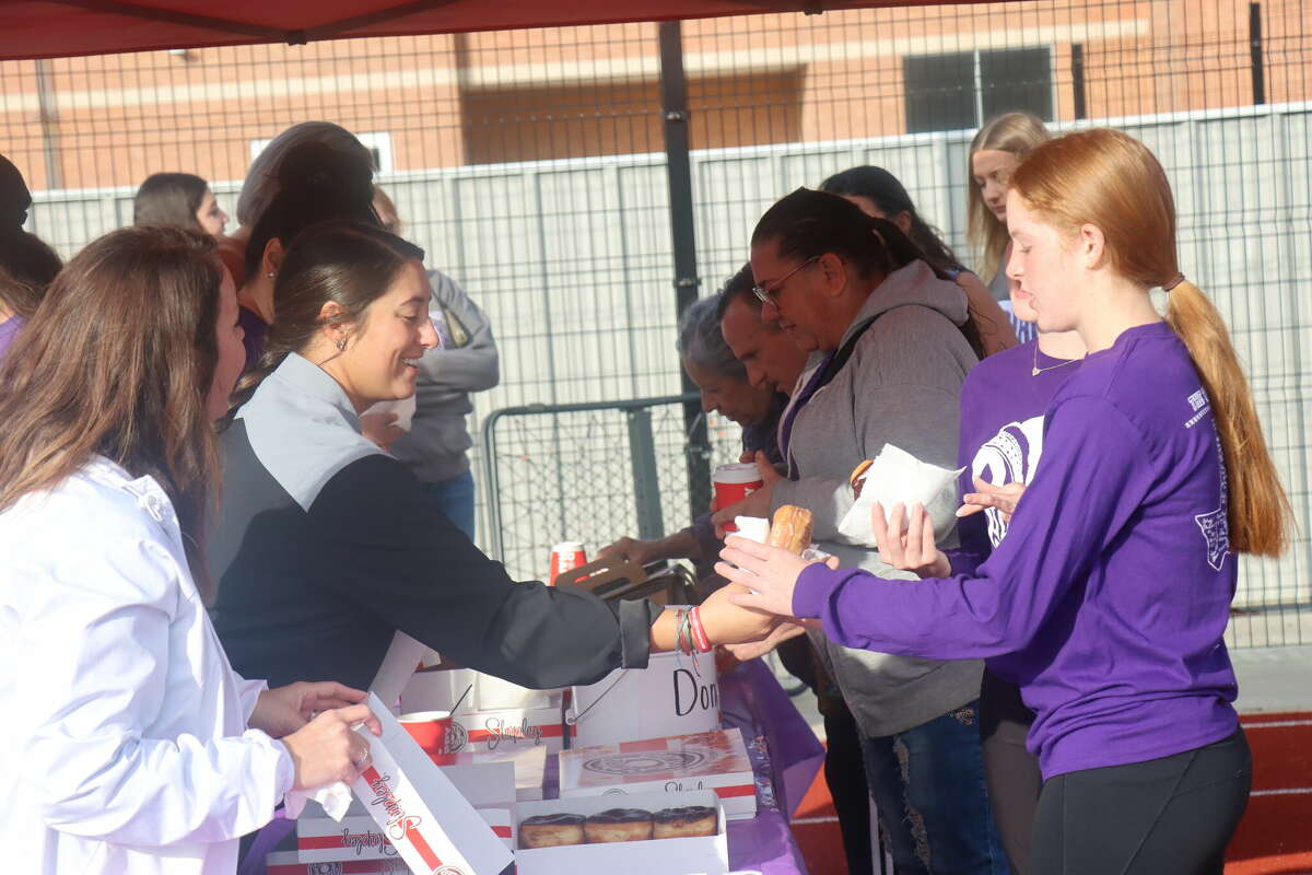 The Port Neches-Groves football booster club provides coffee and donuts for spectators during PN-G's Thanksgiving practice on Thursday, Nov. 24, 2022.