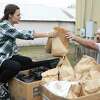 Katie Leggett, left, and Brian Dawson help load 3,000 meals to be distributed for those in need on Thanksgiving Day, Thursday, Nov. 24, 2022, in Conroe. The nonprofit partnered with Montgomery County Meals on Wheels to deliver the meals at three different locations around Montgomery County.
